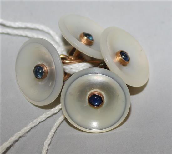 A pair of gold, mother of pearl and cabochon gem set circular cufflinks.